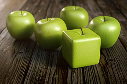 Fünf runde grüne Äpfel und ein quadratischer grüner Apfel auf einer Holzunterlage.